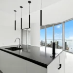 View of the bay from a luxury kitchen at Aston Martin Residences in downtown Miami. Professional real estate photography by Golden Pixxel Media.