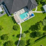 Top-down drone photo of a luxury estate in Redlands Miami showing an expansive backyard and pool area. Aerial photography by Golden Pixxel Media.