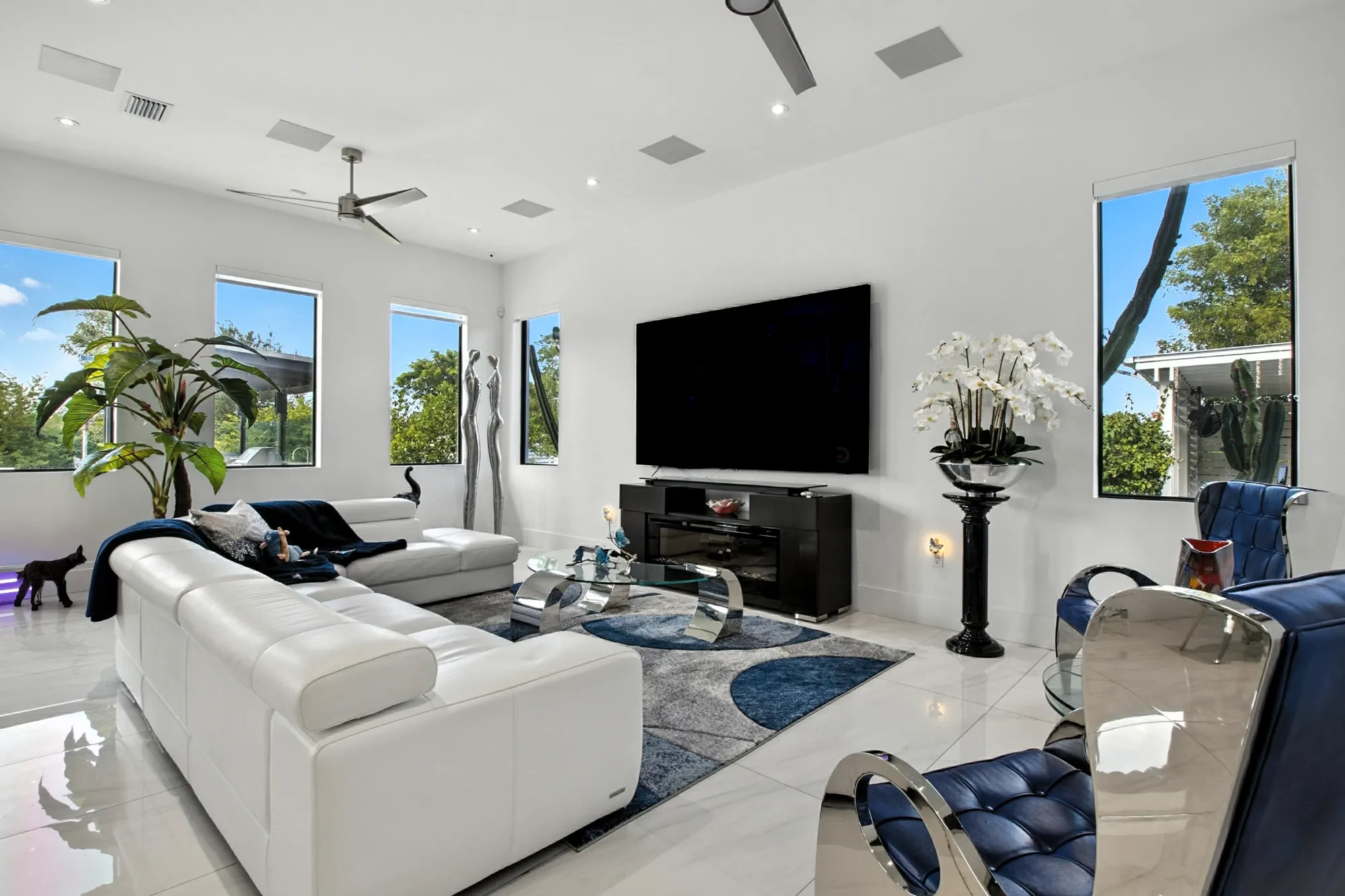 Wide angle view of modern living area at a luxury home in the Homestead Redlands area of Miami. Lots of light and high ceilings. Real estate photography by Golden Pixxel Media.